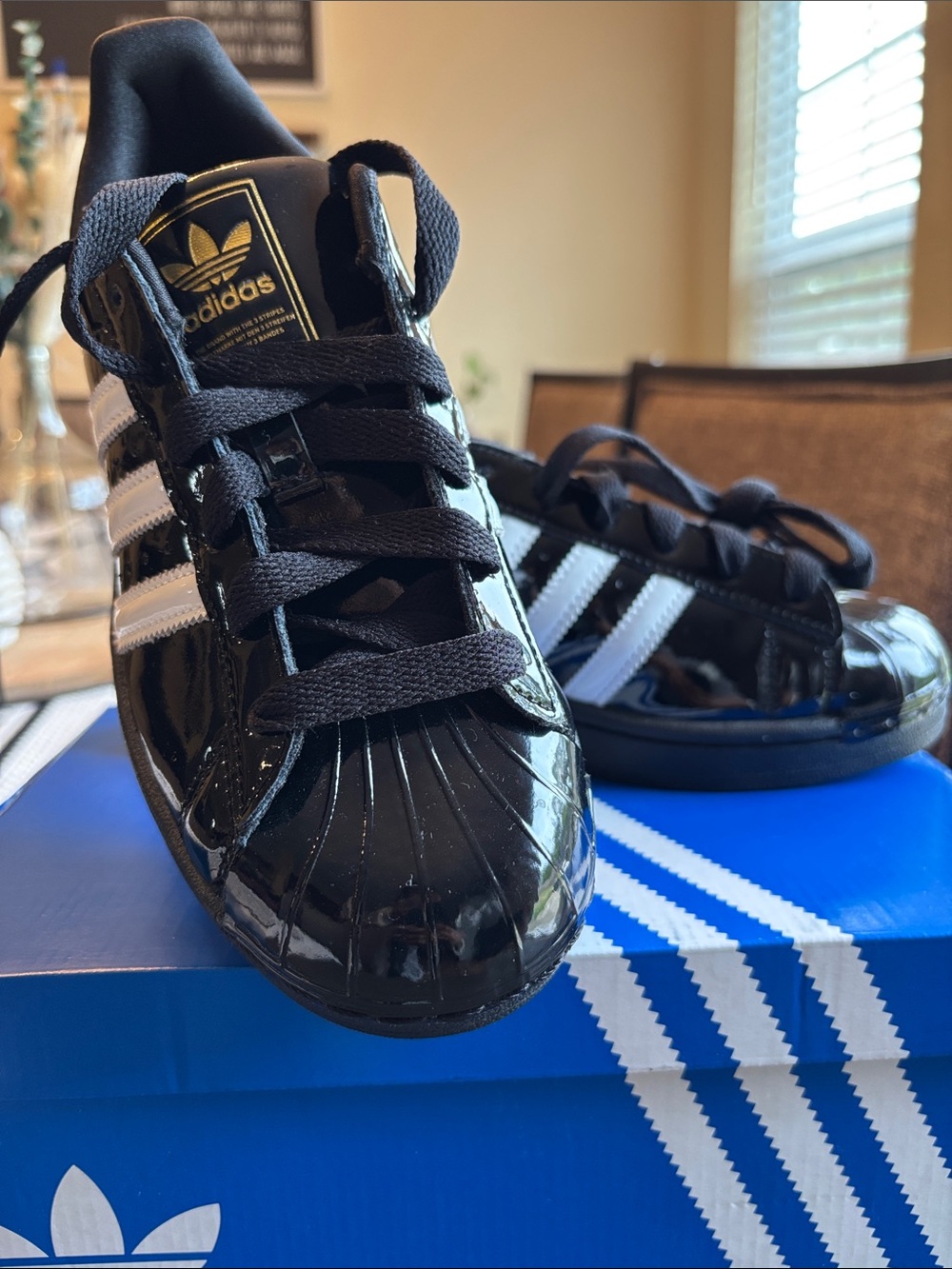 adidas Women’s Black Patent Shell Toe Sneakers with White Stripes